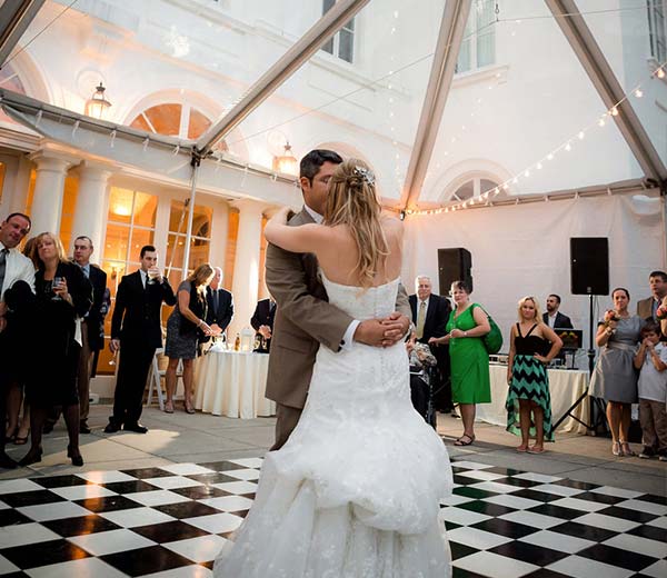 couple dancing underneath a clear frame tent at wedding