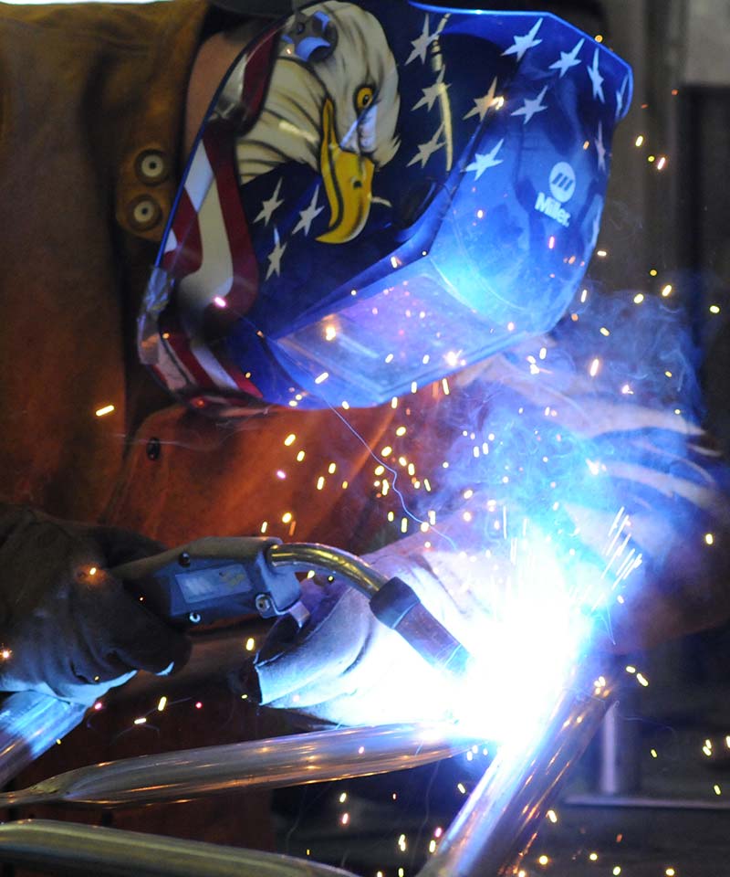 welder working on some tent fittings